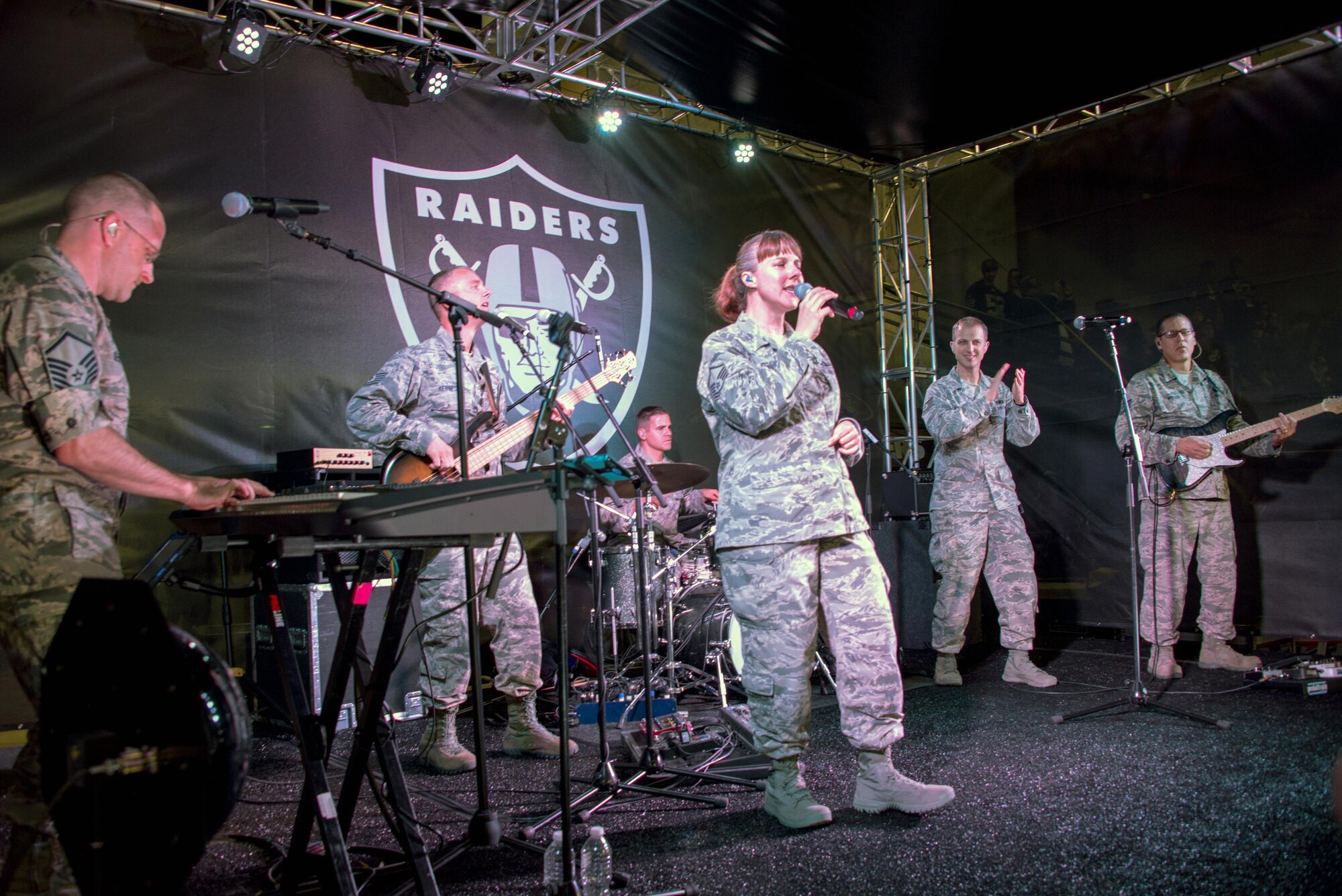 The Air Force Band of the Golden West rock group “Mobility” perform during the halftime show of the Oakland Raiders Salute to Service game against the Denver Broncos at the Oakland Coliseum in Oakland Calif., Nov. 6, 2016. The band is stationed at Travis Air Force Base, Calif., and performed to a live audience of more than 54,000 fans. The band’s performing groups advance Air Mobility Command and global Air Force missions by providing professional musical products and services for official military, recruiting and community relations events. (U.S. Air Force photo by Louis Briscese)