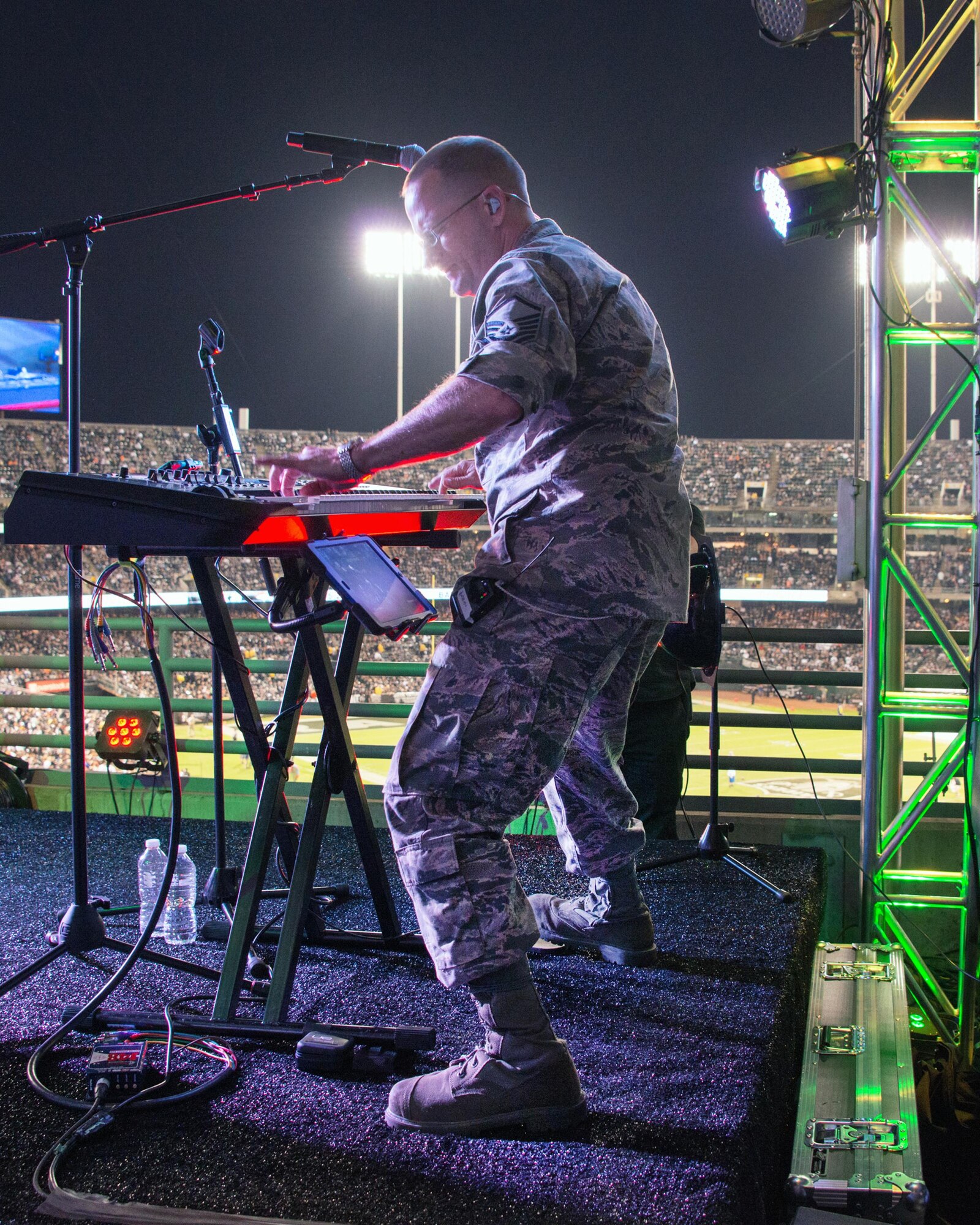 Master Sgt. Andrew Benton, Air Force Band of the Golden West, performs during the band’s halftime show at the Oakland Raiders Salute to Service game against the Denver Broncos at the Oakland Coliseum in Oakland Calif., Nov. 6, 2016. The band is stationed at Travis Air Force Base, Calif., and performed to a live audience of more than 54,000 fans. The band’s performing groups advance Air Mobility Command and global Air Force missions by providing professional musical products and services for official military, recruiting and community relations events. (U.S. Air Force photo/Louis Briscese)