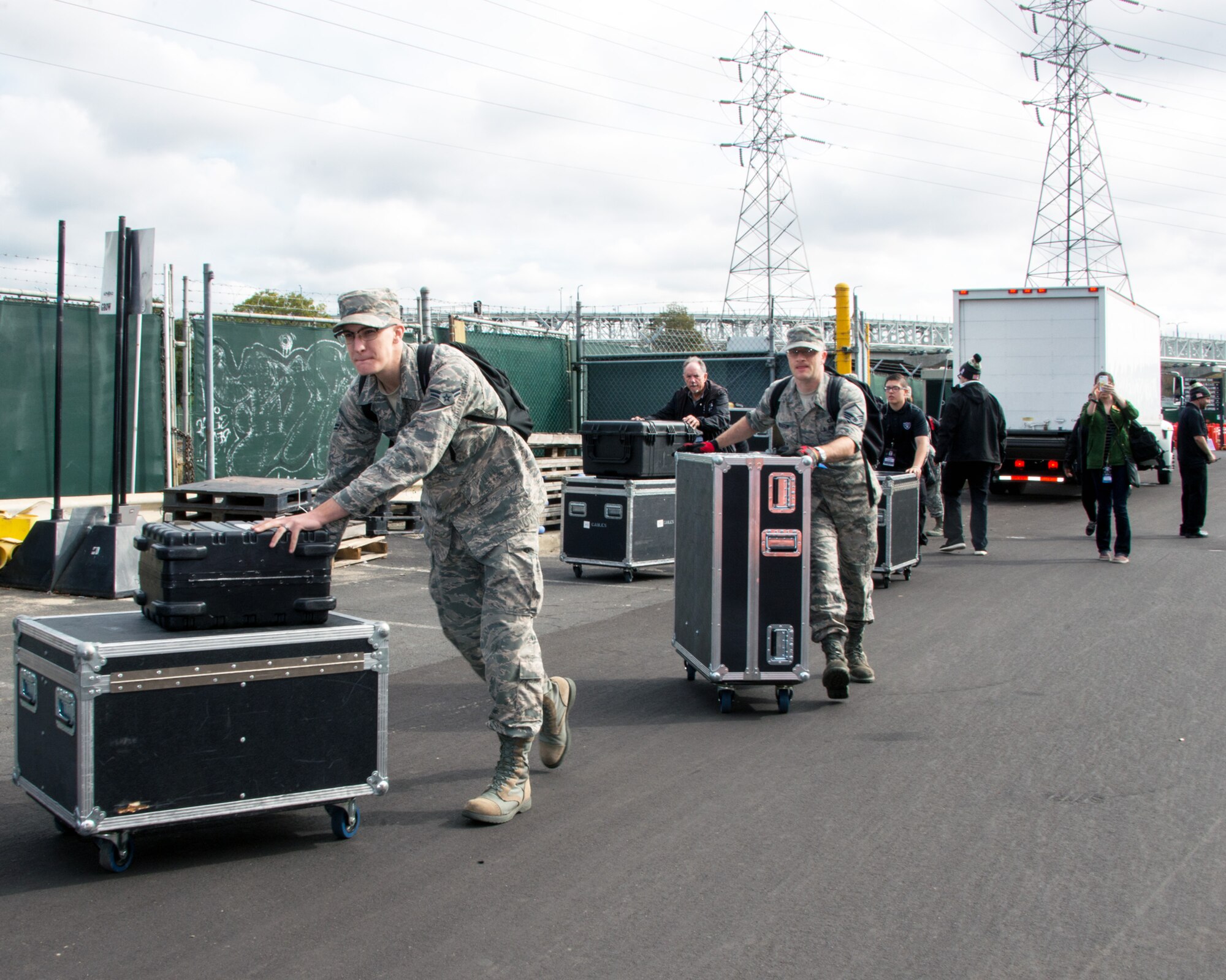 Members of the Air Force Band of the Golden West rock group “Mobility” unload equipment for their halftime show performance at the Oakland Raiders Salute to Service game against the Denver Broncos at the Oakland Coliseum in Oakland Calif., Nov 6, 2016. The band is stationed at Travis Air Force Base, Calif., and performed to a live audience of more than 54,000 fans. The band’s performing groups advance Air Mobility Command and global Air Force missions by providing professional musical products and services for official military, recruiting and community relations events. (U.S. Air Force photo/Louis Briscese)
