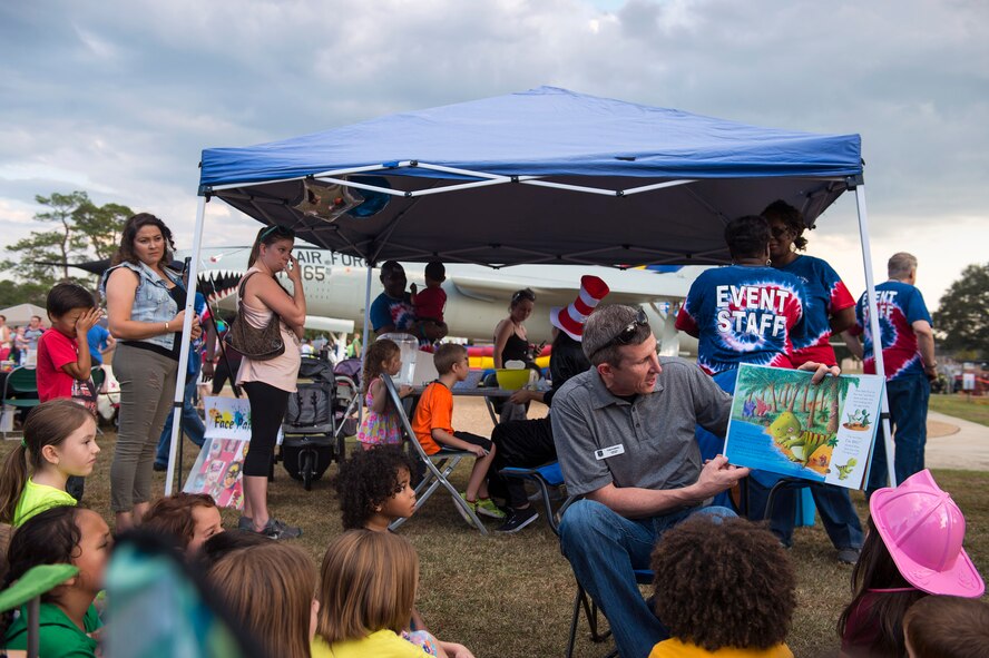 Col. Thomas Kunkel, 23d Wing commander, reads to kids during Moody Fest, Nov. 4, 2016, at Moody Air Force Base, Ga. During the event, Kunkel emphasized the importance of taking care of Airmen and their families at home station and deployed.  (U.S. Air Force photo by Airman 1st Class Greg Nash