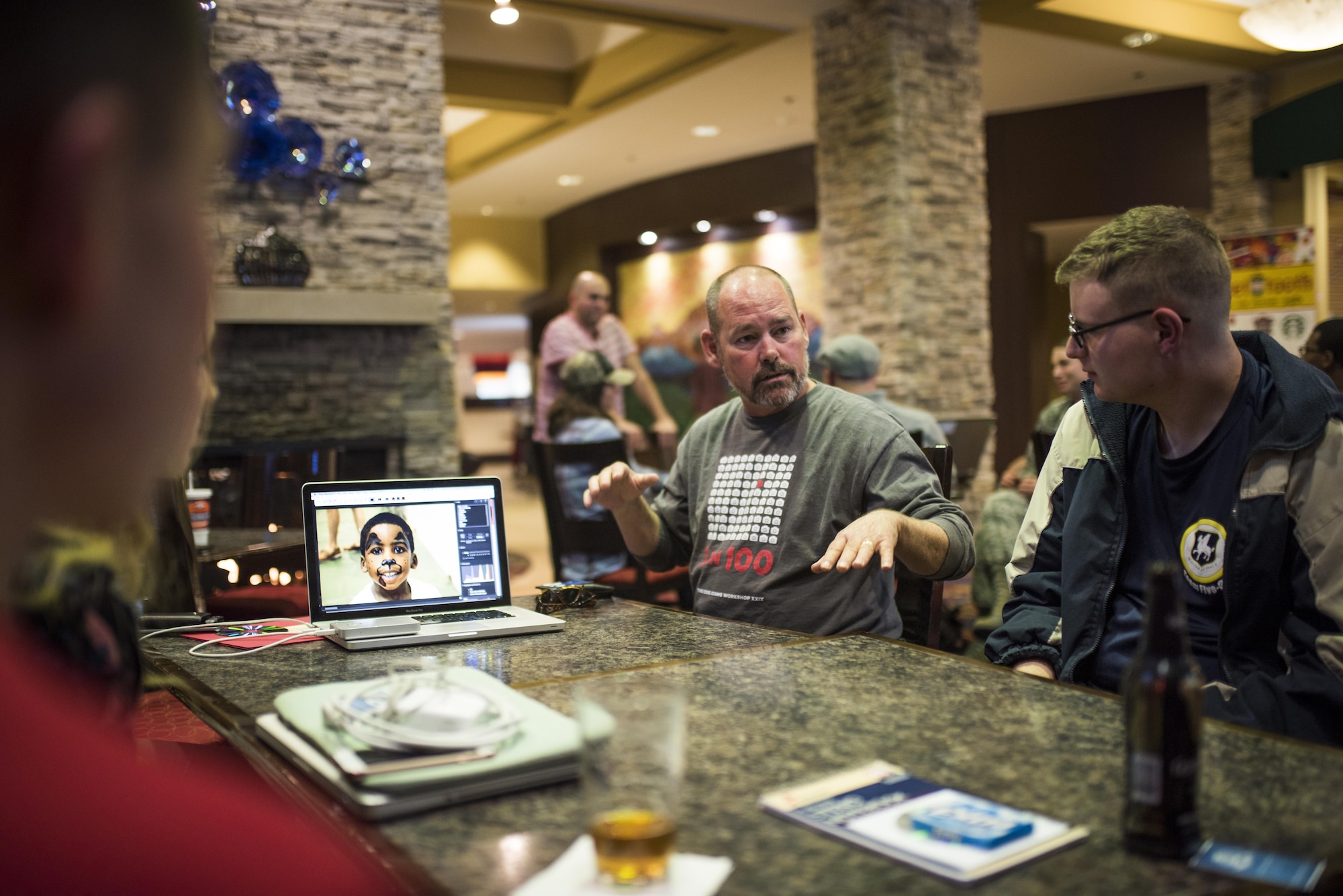 COLORADO SPRINGS, Colo. – Bob Houlihan, Airman Magazine editor-in-chief, discusses photo techniques with Airman 1st Class William Tracy, 50th Space Wing Public Affairs photojournalist from Schriever Air Force Base, during the inaugural Air Force Space Command Visual Storytelling Workshop in Colorado Springs, Nov. 1-4, 2016. The workshop was held for AFSPC photojournalists to come together with industry experts and learn how to tell a story through a camera lens. (U.S. Air Force photo by Tech. Sgt. David Salanitri)
