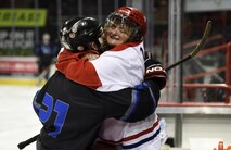 Senior Airman Taylor Swartz, a Fairchild Falcons hockey player, gets a surprise visit from his mother during a scrimmage game between members of the Fairchild Falcons varsity hockey team at the Spokane Arena, Nov. 5, 2016, Spokane, Wash.  The Fairchild Falcons are a varsity sports team comprised of active duty, guard, civilians, retirees and dependents from Fairchild and surrounding areas to create a fully integrated team. (U.S. Air Force photo/Airman 1st Class Sean Campbell)