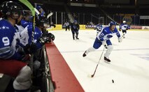 Senior Airman Justin Killingsworth, a Fairchild Falcons hockey player, carries the puck down the hockey rink during a scrimmage game at the Spokane Arena Nov. 5, 2016, Spokane, Wash. The final score had the blue jerseys win with four goals scoring one goal in overtime while the white jerseys finished with three goals. (U.S. Air Force photo/Airman 1st Class Sean Campbell)