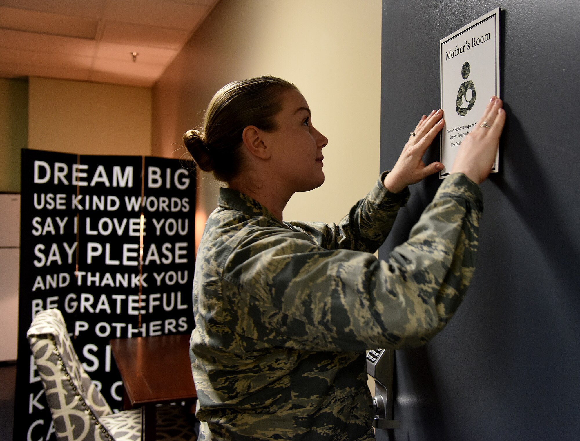 1st Lt. Annabel Monroe, 341st Missile Wing Public Affairs chief of media operations, adjusts a sign on the door of one of the five mother’s rooms at Malmstrom Air Force Base, Mont., Nov. 8, 2016. Monroe renovated five rooms for mothers to have a secure and clean environment to breast-feed or pump. (U.S. Air Force photo/Senior Airman Jaeda Tookes)

