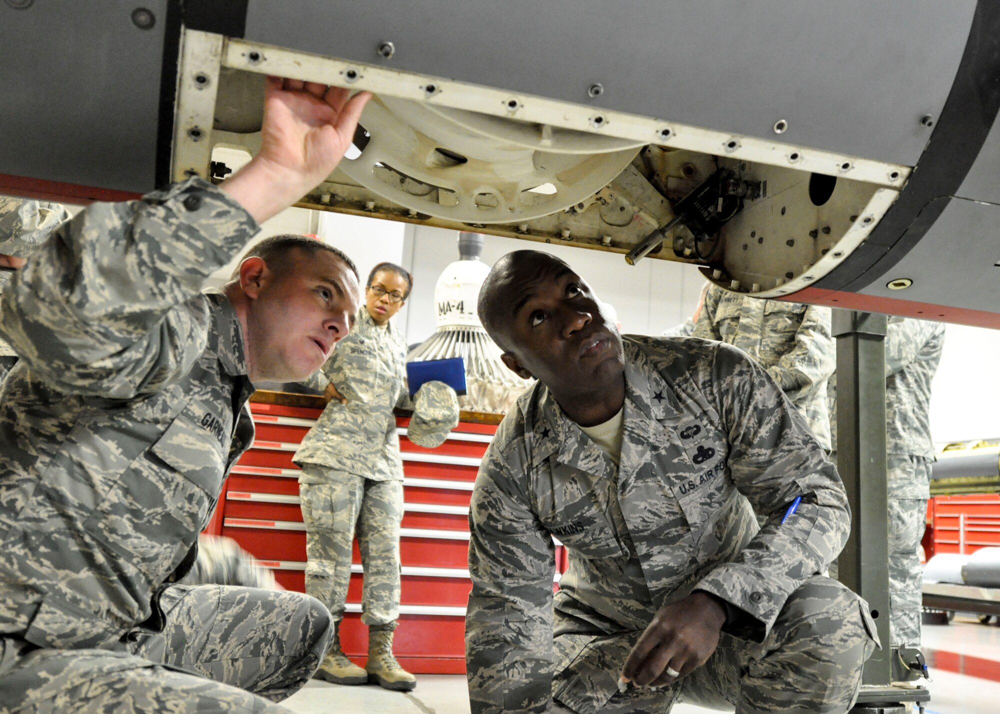Master Sgt. Dustin Garneau shows Brig. Gen. Stacey Hawkins part of a KC-135 Stratotanker that had been brought in for repair Nov. 7, 2016, at Fairchild Air Force Base, Wash. Hawkins is the Air Mobility Command director of logistics, engineering and force protection, his visit included a tour of the hydraulics shop from Garneau, who is the 92nd Maintenance Squadron NCO in charge of aircraft hydraulics. (U.S. Air Force photo/Airman 1st Class Taylor Shelton)