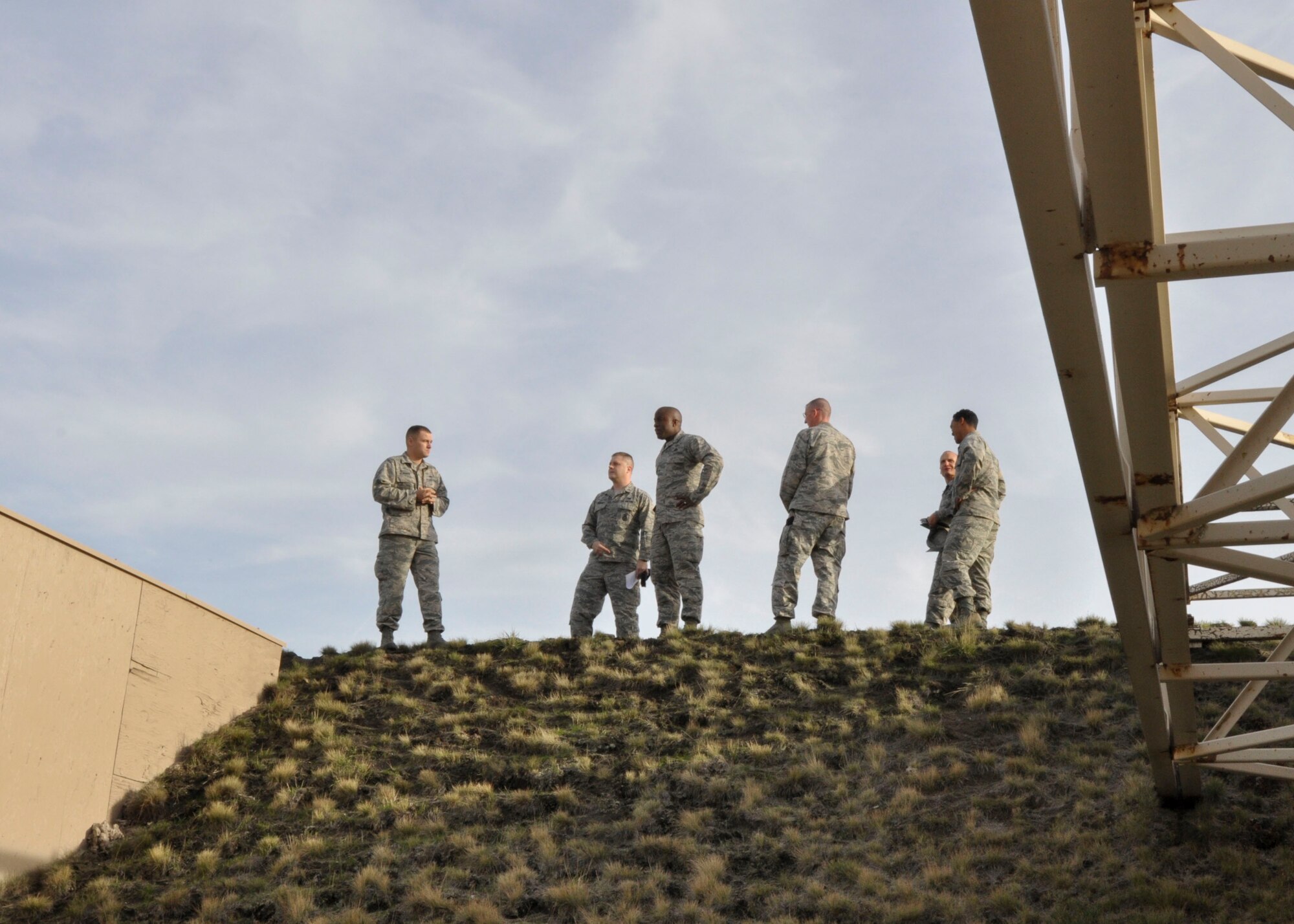 Brig. Gen. Stacey Hawkins, Air Mobility Command director of logistics, engineering and force protection, (seen center), speaks with members of the 92nd Security Forces Squadron at the top of the combat arms range during a base tour Nov. 7, 2016, at Fairchild Air Force Base, Wash. The embankment surrounding the range prevents gunfire from escaping the enclosed area. Hawkins visited the security forces squadron, maintenance squadron and the fire department during the tour. (U.S. Air Force photo/Airman 1st Class Taylor Shelton)
