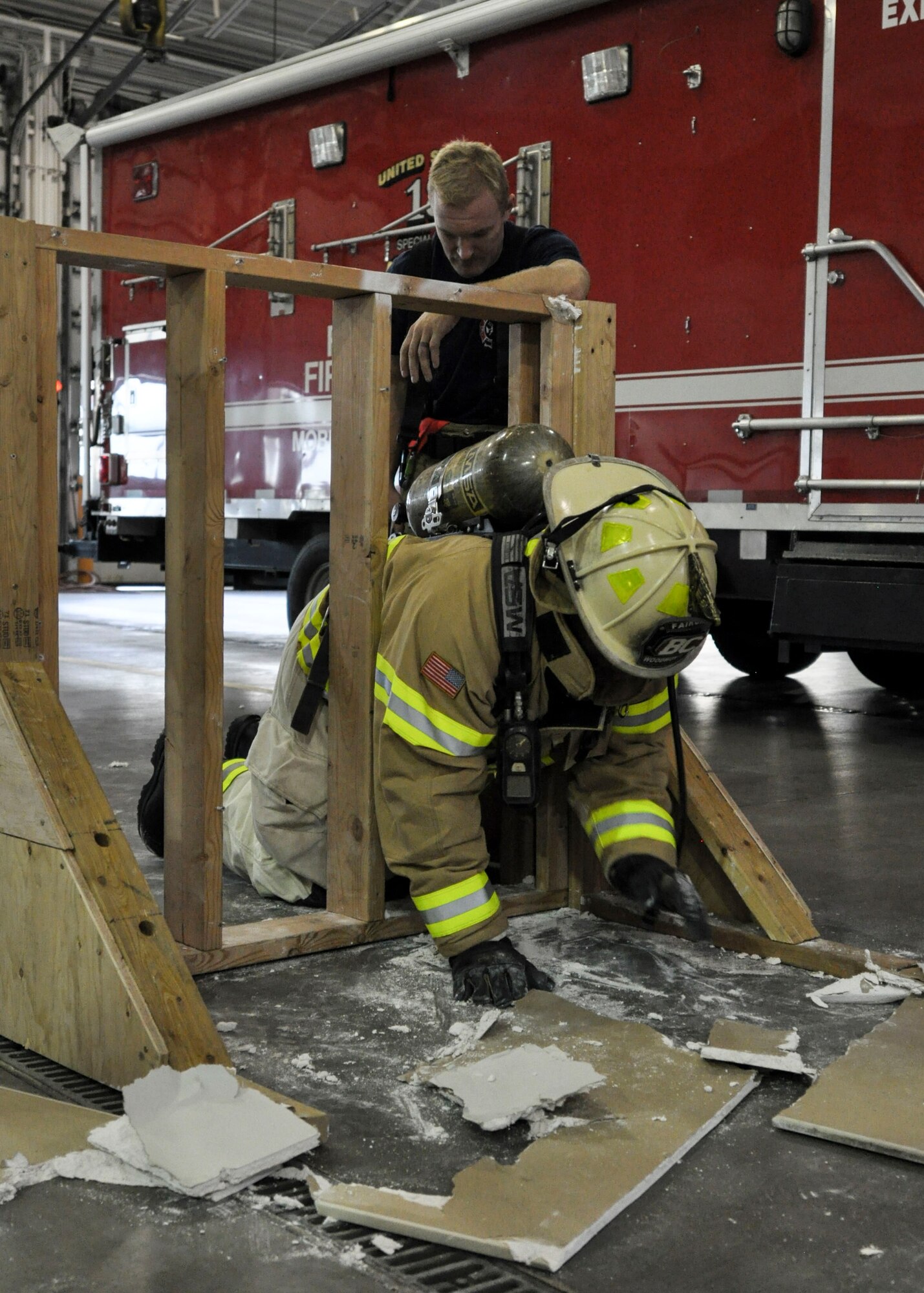 Brig. Gen. Stacey Hawkins, Air Mobility Command director of logistics, engineering and force protection, crawls through a 16-inch cut out during a base tour Nov. 7, 2016, at Fairchild Air Force Base, Wash. The 92nd Civil Engineer Squadron Fire Department put on a demonstration showcasing the training they do, allowing Hawkins to participate in a portion at the end. (U.S. Air Force photo/Airman 1st Class Taylor Shelton)