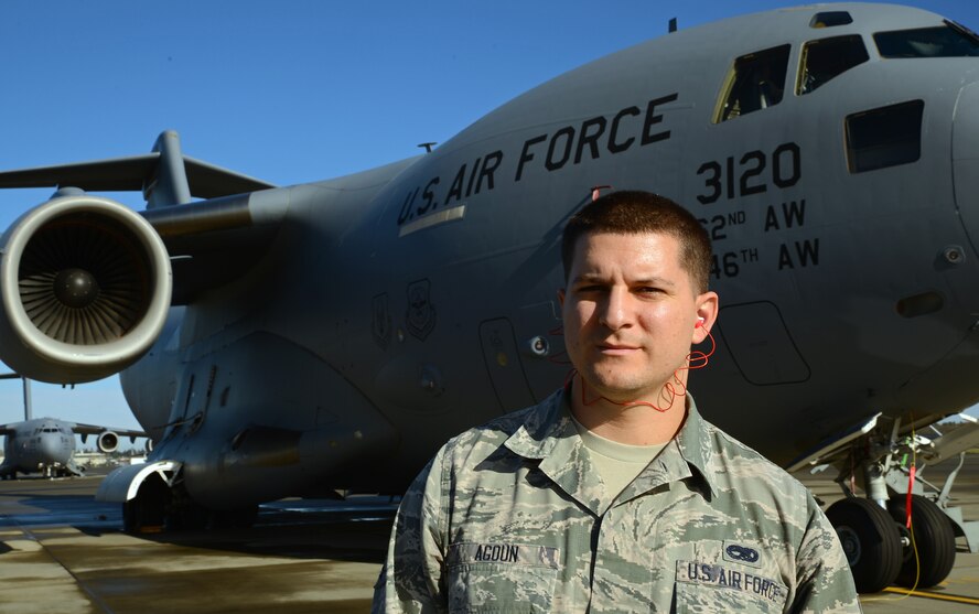 Senior Airman Jamal Agoun, 62nd Aircraft Maintenance Squadron instrument and flight control systems apprentice, poses in front of a C-17 Globemaster III aircraft Nov. 3, 2016, at Joint Base Lewis-McChord, Wash. Agoun was selected as the 62nd AMXS Spotlight for outstanding performance.(U.S. Air Force photo/Senior Airman Jacob Jimenez)     