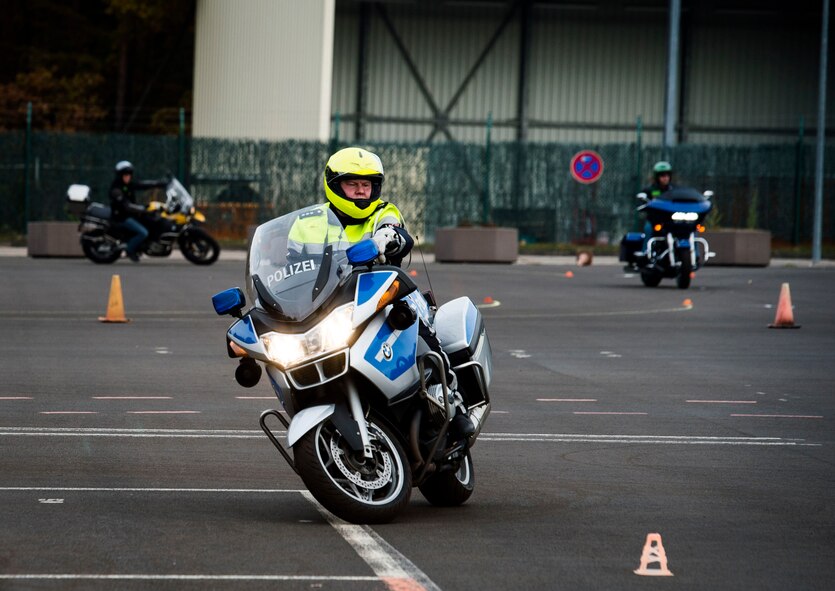 A German police officer participates in a motorcycle safety rodeo at Kapaun Air Station, Germany, with RiderCoaches from the Kaiserslautern Military Community, Nov. 4, 2016. The 86th Airlift Wing safety office sponsored the event, arranging for Polizei to come and teach the RiderCoaches maneuvers which would be helpful in case of hazardous situations. (U.S. Air Force photo by Airman 1st Class Joshua Magbanua)