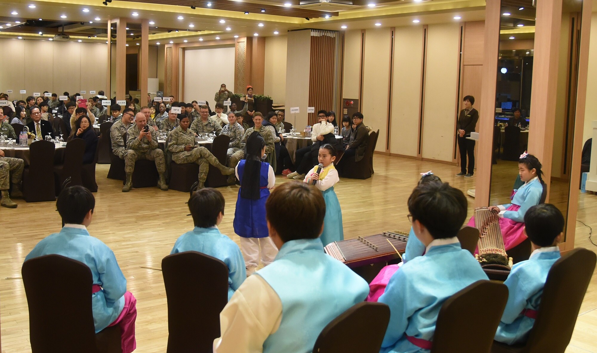 Students from Dangbook Elementary School perform a traditional Korean play during a volunteer appreciation night at the Hanwon Convention room in the city of Gunsan, Republic of Korea, Nov. 8, 2016. The students participated in an English language program taught by 8th Fighter Wing airmen. (U.S. Air Force photo by Tech. Sgt. Jeff Andrejcik/Released)