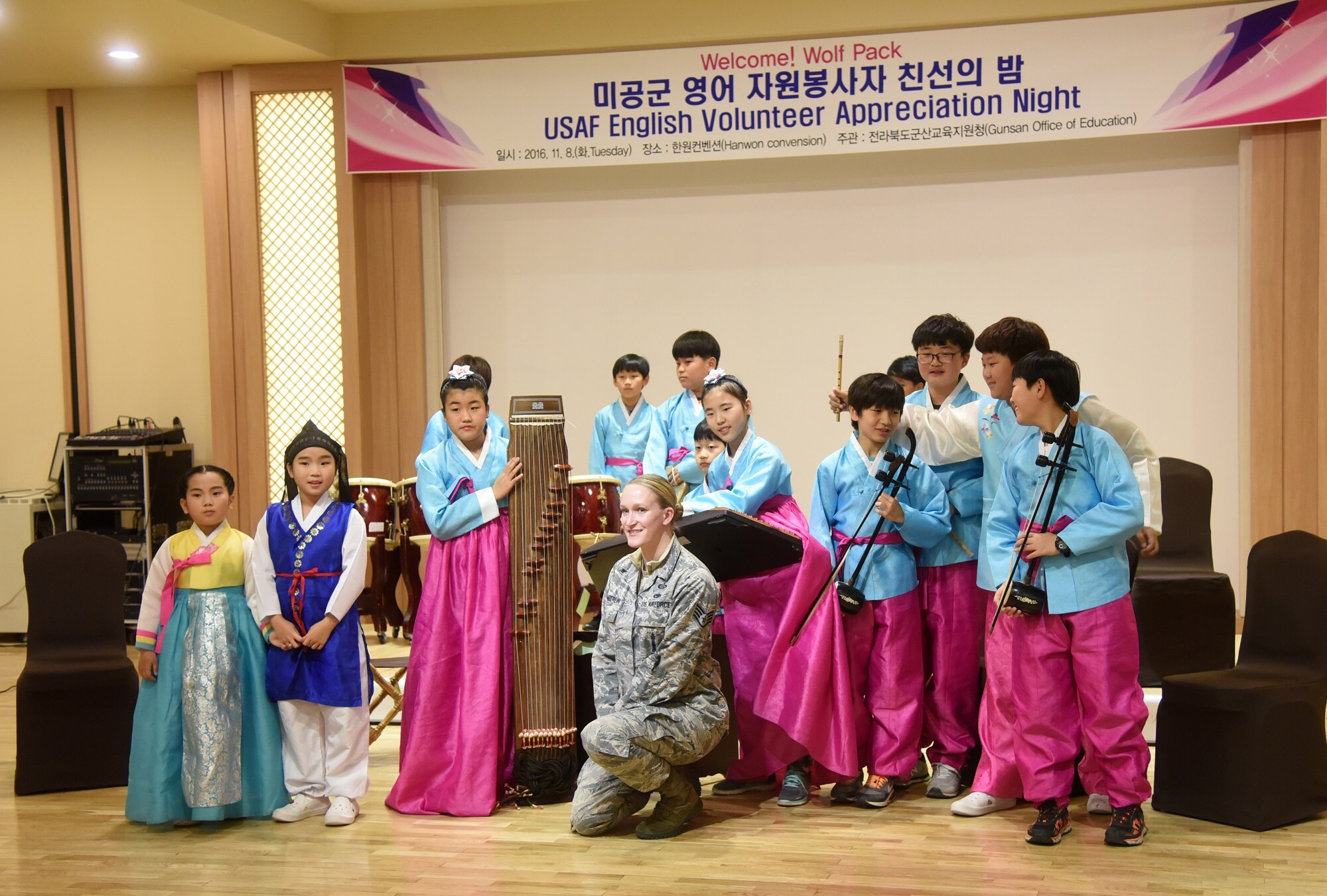 Staff Sgt. Robbin Toumberlin, 8th Operations Support Squadron noncommissioned officer in charge targets intelligence, is recognized with her students during an appreciation night at the Hanwon Convention room in the city of Gunsan, Republic of Korea, Nov. 8, 2016. Toumberlin taught English to local students in Gunsan City as a volunteer. (U.S. Air Force photo by Tech. Sgt. Jeff Andrejcik/Released)