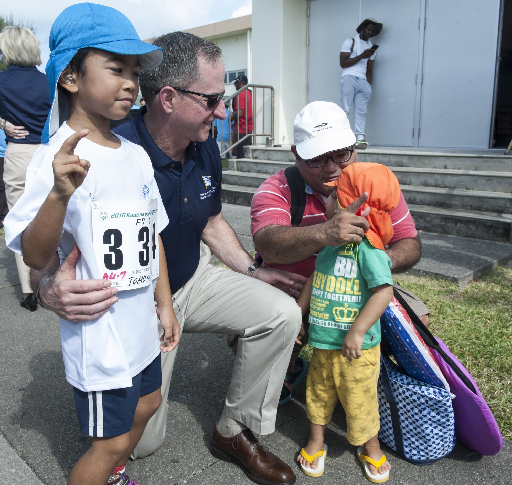 Air Force Chief of Staff Gen. Dave Goldfein takes a photo with a local Okinawan family during the Kadena Special Olympics Nov. 5, 2016, at Kadena Air Base, Japan. Established by the 18th Wing commander in 2000, KSO is a wholesome sporting and entertainment event that provides an opportunity for all communities involved to stand together in support of people with special needs. (U.S. Air Force photo by Senior Airman Lynette M. Rolen)
