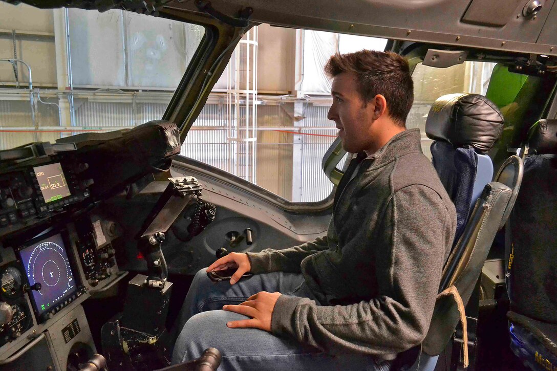 John Procopio, a contract specialist with the Subsistence supply chain, sits in the co-pilot’s seat of an Air Force C-17 Globemaster III cargo plane at Joint Base McGuire-Dix-Lakehurst, New Jersey Nov. 2. As part of Troop Support Academy, more than 100 employee visited the base’s aircraft, firehouse, dining facility and a global crisis-response unit.