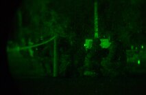 Airmen assigned to the 1st Combat Communications Squadron kneel in formation during exercise Healthy Thunder at Ramstein Air Base, Germany, Nov. 3, 2016. The Airmen performed tactical movements to retrieve supplies during the field training exercise portion of Healthy Thunder. The purpose of the exercise was to prepare 1st CBCS Airmen for deployments.  (U.S. Air Force photo by Senior Airman Tryphena Mayhugh)