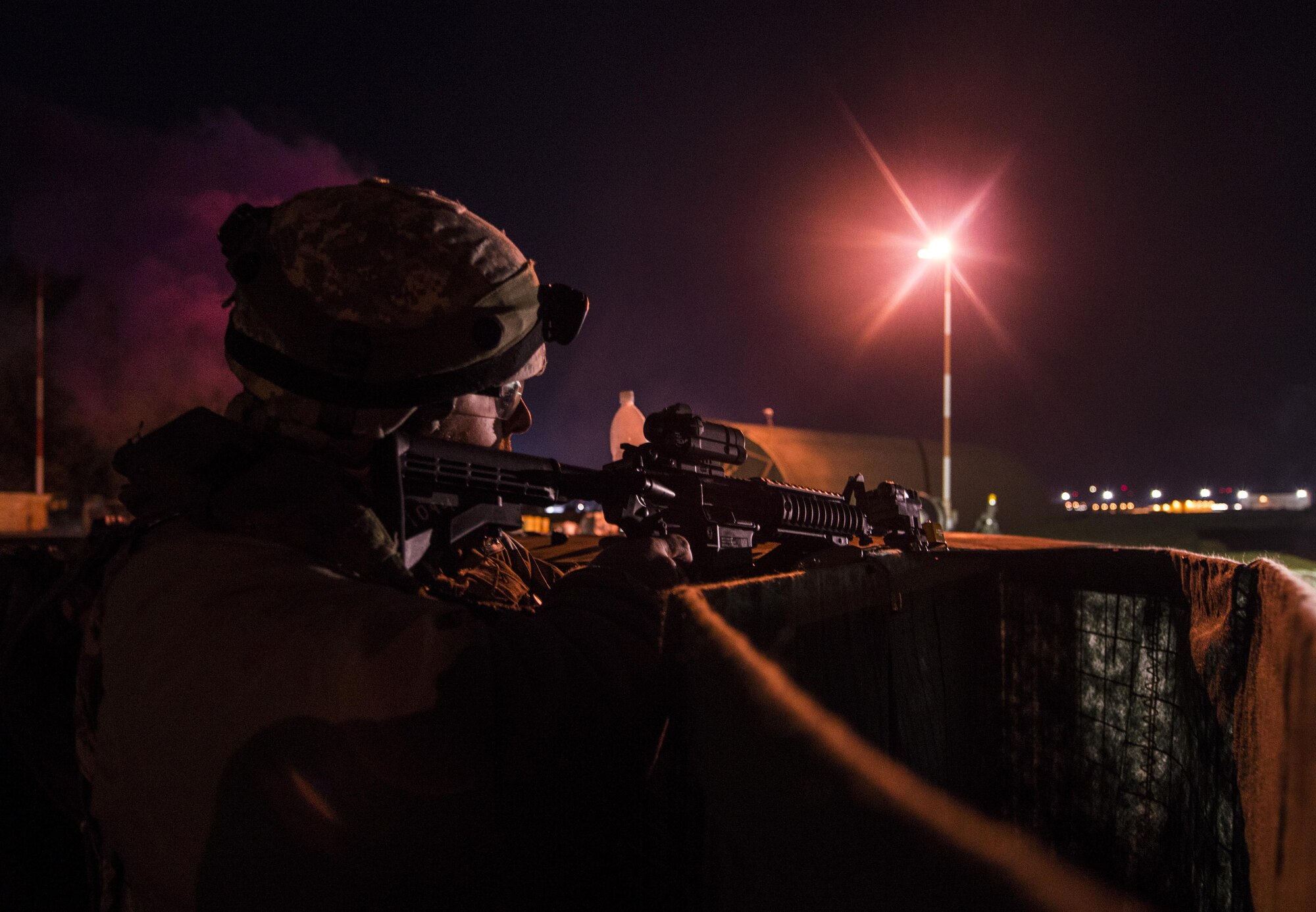 Staff Sgt. Bartley Henriques, 1st Combat Communications Squadron cyber transport section chief, fires blanks from an M-16 rifle to defend a base during exercise Healthy Thunder at Ramstein Air Base, Germany, Nov. 3, 2016. During the field training exercise portion, several 1st CBCS Airmen played the role of opposing forces to attack the site to prepare the Airmen participating in the exercise for a deployment. (U.S. Air Force photo by Senior Airman Tryphena Mayhugh)