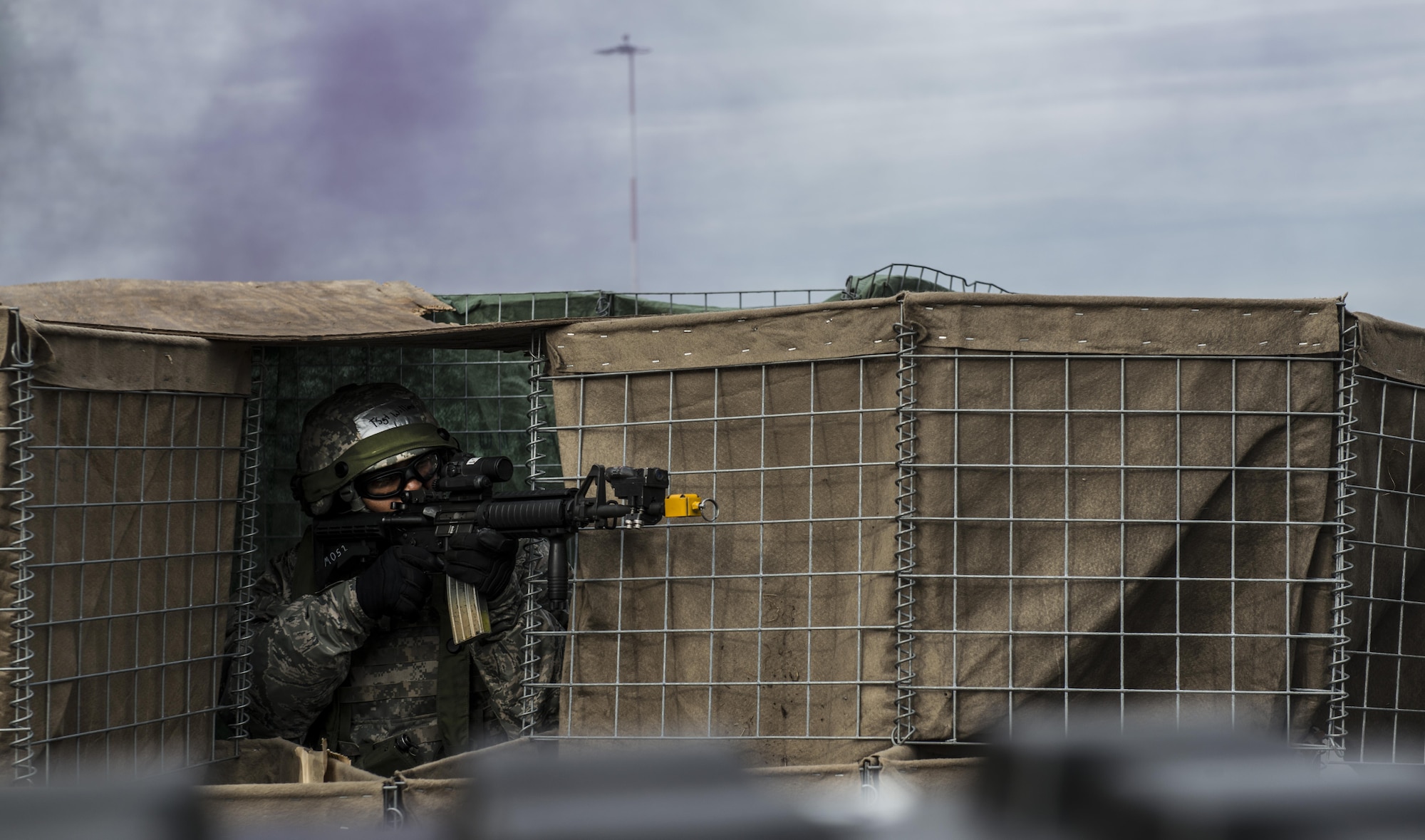 Tech. Sgt. Chad Williams, 1st Combat Communications Squadron NCO in charge of tactical network operations, fires blanks from an M-16 rifle to defend a base during exercise Healthy Thunder at Ramstein Air Base, Germany, Nov. 4, 2016. Fifty-eight Airmen participated in the exercise, which included setting up communications and defending a base in a deployed location. (U.S. Air Force photo by Senior Airman Tryphena Mayhugh)