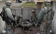 Airmen assigned to the 1st Combat Communications Squadron place an “injured” Airman on a stretcher during exercise Healthy Thunder at Ramstein Air Base, Germany, Nov. 4, 2016. Fifty-eight Airmen participated in the exercise to prepare for a deployment. (U.S. Air Force photo by Senior Airman Tryphena Mayhugh)