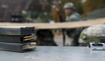 Three magazine clips lay on a barrier during exercise Healthy Thunder at Ramstein Air Base, Germany, Nov. 4, 2016. Airmen assigned to the 1st Combat Communications Squadron participated in the exercise and fired blanks during the field training exercise portion of Healthy Thunder to simulate real-world combat situations. (U.S. Air Force photo by Senior Airman Tryphena Mayhugh)