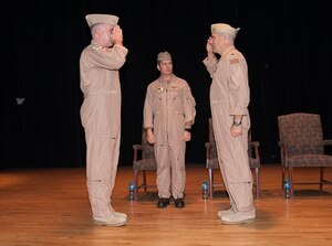 Capt. Christopher Flaherty (left) salutes Capt. Brett Coffey (right) during U.S. Naval Forces Central Command’s (NAVCENT) maritime patrol force, Commander, Task Force (CTF) 57’s change of command, officiated by Vice Adm. Kevin Donegan, commander of NAVCENT (center), at Naval Support Activity Bahrain on Nov. 8, 2016. CTF 57 provides maritime patrol and reconnaissance aircraft throughout the U.S. 5th Fleet area operations. 