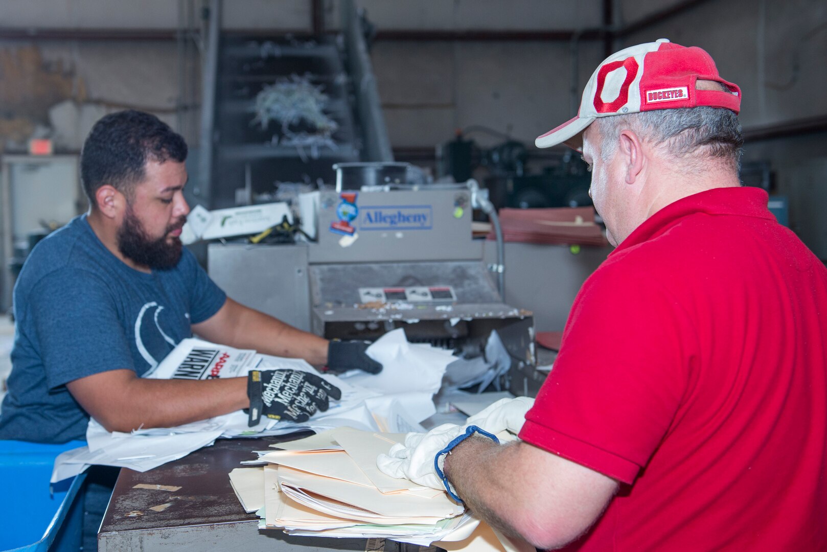 John Perez and Russ LePage, 502nd Civil Engineer Squadron motor vehicle operators, shred paper Nov. 2, 2016, at the Joint Base San Antonio-Lackland Recycling Center. Recycling one ton of paper saves 682.5 gallons of oil, 7000 gallons of water, between 17 and 31 trees, 3.3 cubic yards of landfill space, 4000 kilowatts of energy, and 7000 gallons of water. 