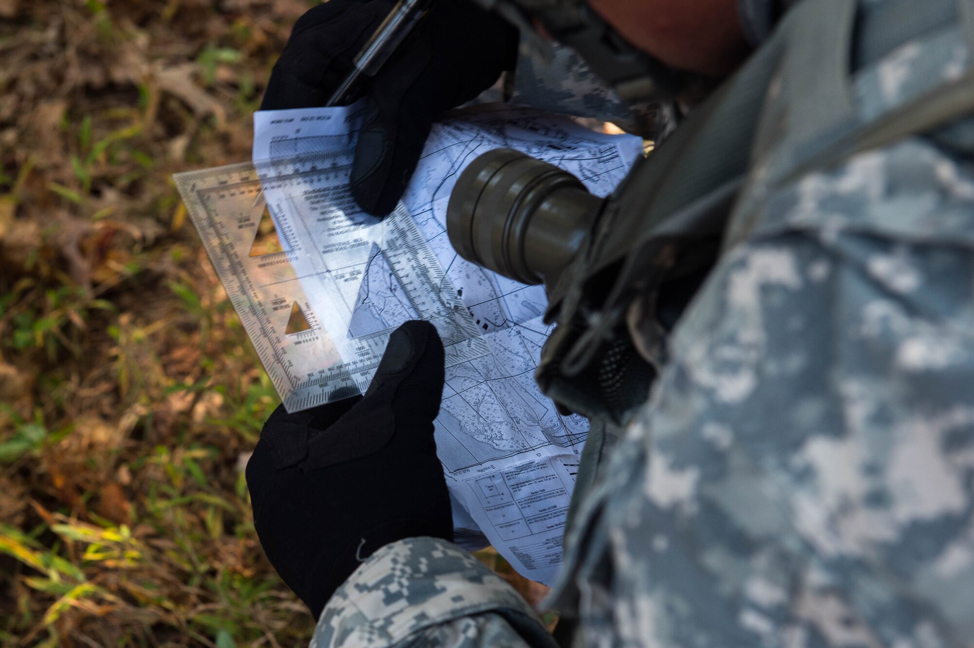 U.S. Army Pfc. Dennis Radican, 1098th Transportation Company, 11th Trans. Battalion, 7th Trans. Brigade (Expeditionary) watercraft operator, determines the distance to the platoon’s next objective during a training exercise at Joint Base Langley-Eustis, Va., Nov. 3, 2016. Radican ensured the line of communication between headquarters and his platoon stayed open and fluid during the exercise. (U.S. Air Force photo by Airman 1st Class Derek Seifert)