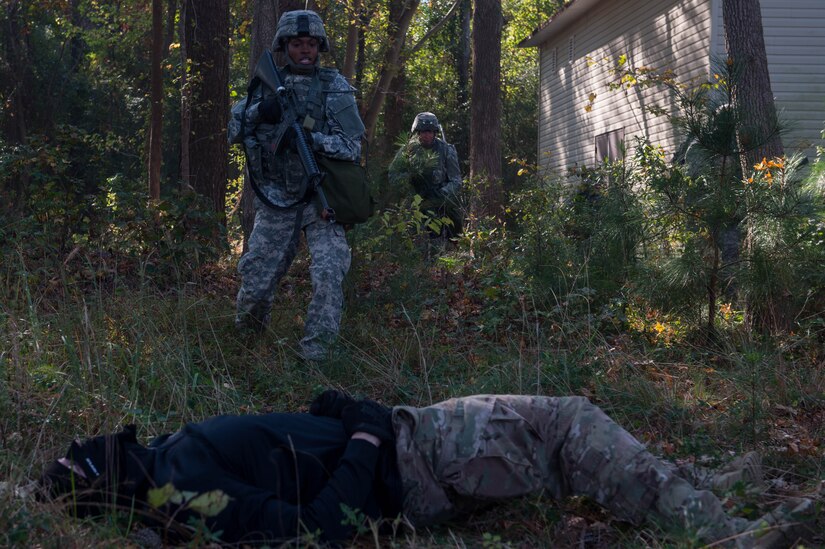 U.S. Army Sgt. Zanquandria Joseph, 1098th Transportation Company, 11th Trans. Battalion, 7th Trans. Brigade (Expeditionary) watercraft operator, runs up to a simulated wounded enemy combatant during a training exercise at Joint Base Langley-Eustis, Va., Nov. 3, 2016. During the exercise the Soldiers were ambushed on a road with gas and small arms fire by instructors who played enemies. (U.S. Air Force photo by Airman 1st Class Derek Seifert)