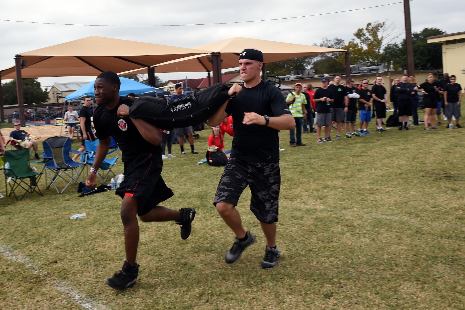 The 559th Medical Group team carries a 100-pound sandbag during the “Don’t Sand Bag Me, Bro” competition on Joint Base San Antonio-Lackland, Texas, Nov. 4. Working in pairs, teams competed to be the first to carry the sandbag 600 feet. (U.S. Air Force photo/Staff Sgt. Jason Huddleston)