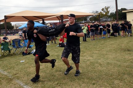 The 559th Medical Group team carries a 100-pound sandbag during the “Don’t Sand Bag Me, Bro” competition on Joint Base San Antonio-Lackland, Texas, Nov. 4. Working in pairs, teams competed to be the first to carry the sandbag 600 feet. (U.S. Air Force photo/Staff Sgt. Jason Huddleston)