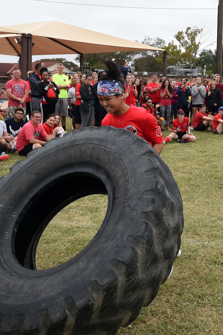 Senior Airman Samouth Thompson, a member of the 959th Medical Group’s Ultimate Warrior Medic Challenge team, flips a 150-pound tire during the Warrior Medic Challenge held Nov. 4 on Joint Base San Antonio-Lackland, Texas. (U.S. Air Force photo/Staff Sgt. Jason Huddleston)