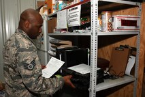Staff Sgt. Kerry Lewis, a 386th Expeditionary Communications Squadron client systems supervisor,  retrieves a laptop for a customer at an undisclosed location in Southwest Asia Nov. 8, 2016. Lewis is deployed from the 2nd Communications Squadron at Barksdale Air Force Base, La. (U.S. Air Force photo by Senior Airman Andrew Park/Released)