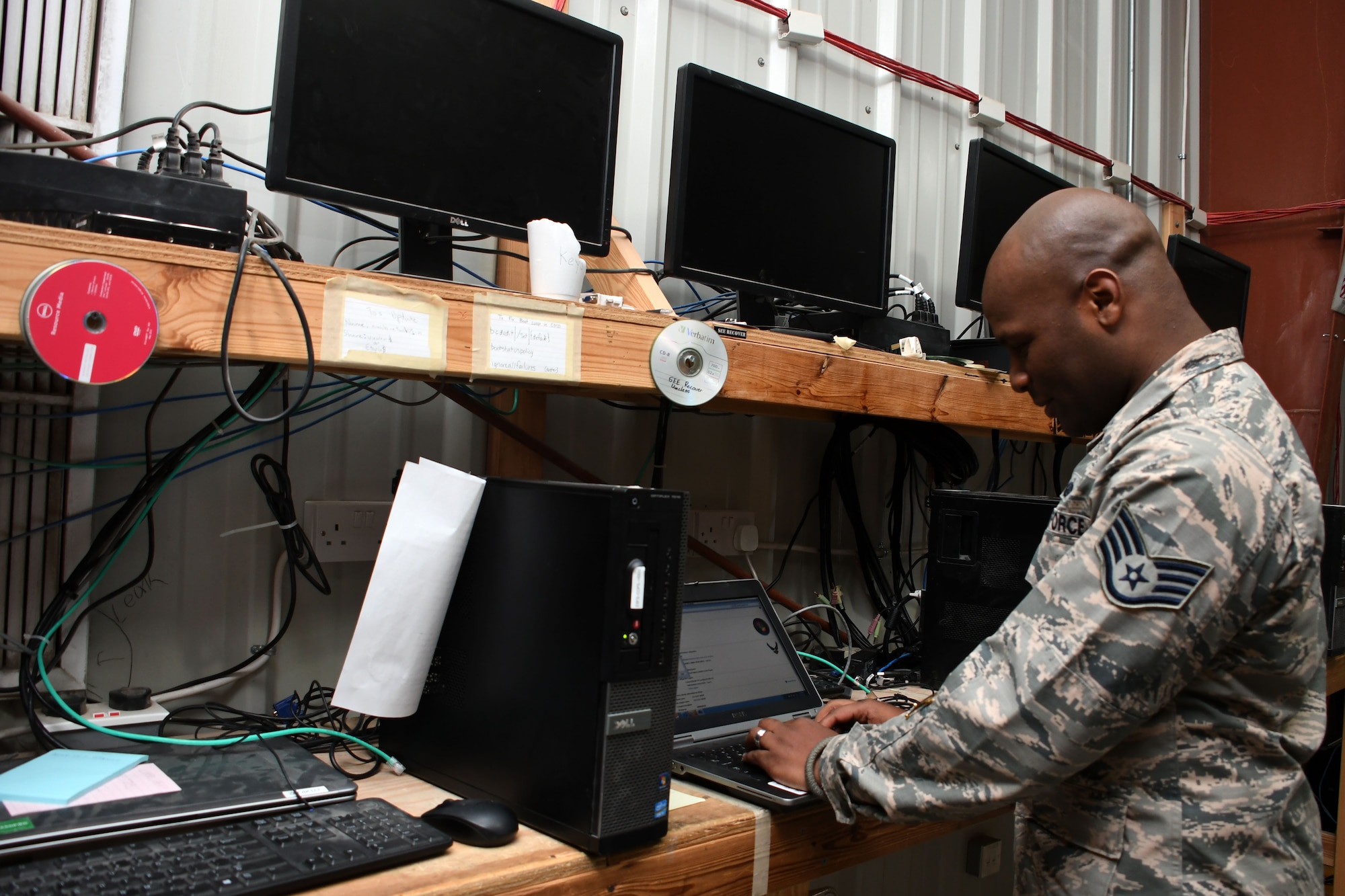 Staff Sgt. Kerry Lewis, a 386th Expeditionary Communications Squadron client systems supervisor,  examines a laptop for a customer at an undisclosed location in Southwest Asia Nov. 8, 2016. Lewis is deployed from the 2nd Communications Squadron at Barksdale Air Force Base, La. (U.S. Air Force photo by Senior Airman Andrew Park/Released)