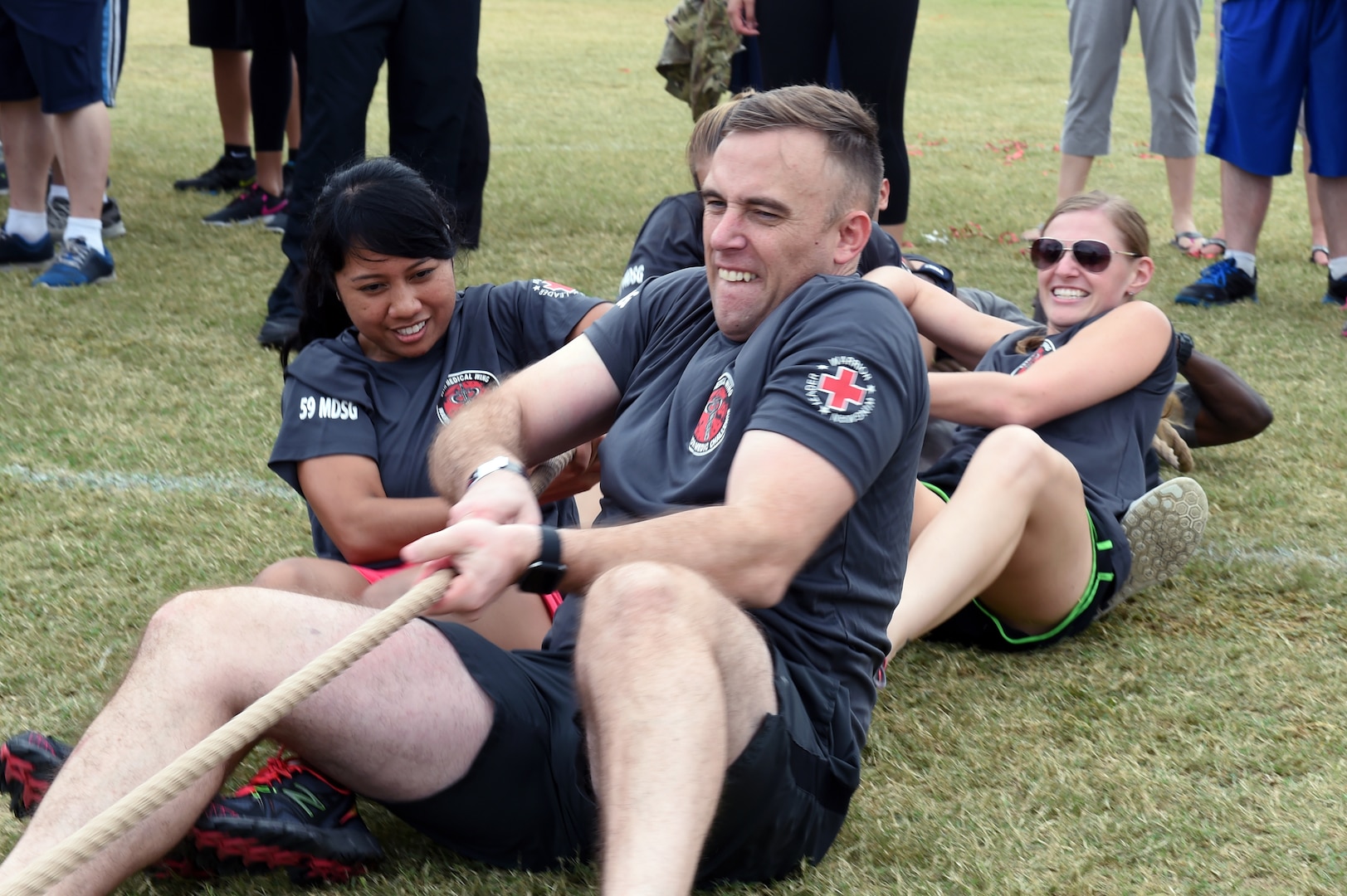 The team from the 59th Medical Support Group pulls a 150-pound tire during the “Latimus Maximus” competition Nov. 4 on Joint Base San Antonio-Lackland, Texas. Teams worked in groups of six on each side - dragging the tire 50 feet as many times as they could in five minutes. The event brought members of the 59th Medical Wing together for a day of friendly, spirited competition designed to build camaraderie. (U.S. Air Force photo/Staff Sgt. Jason Huddleston)