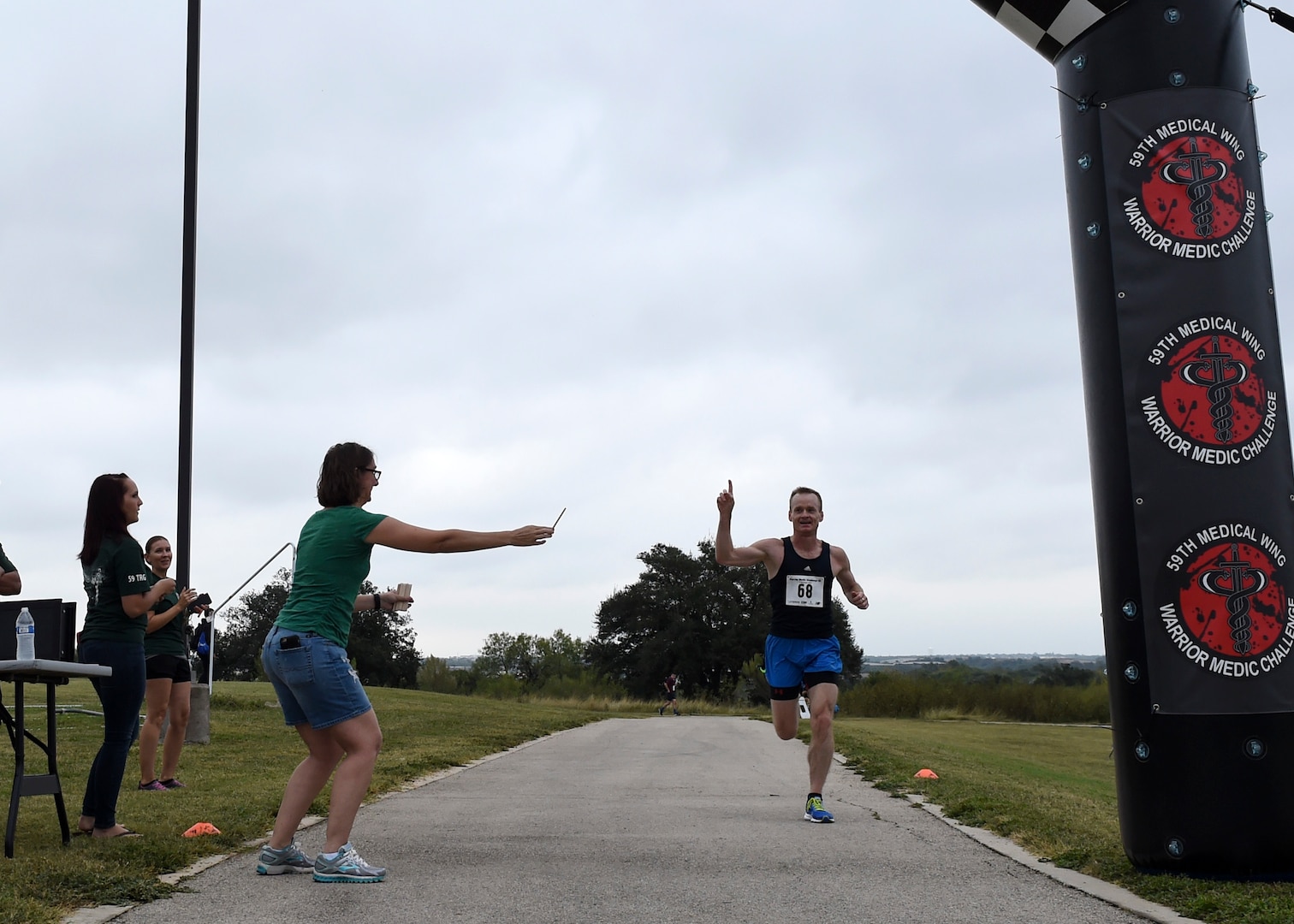 Army Maj. James Neiner, 59th Medical Operations Group dermatologic surgeon, sprints through the 5K finish line during the Warrior Medic Challenge held Nov. 4, 2106 on Joint Base San Antonio-Lackland, Texas. Neiner was the first runner to finish the 5K run, helping his team, 59th MDOG, earn 70 points during the event. (U.S. Air Force photo/Staff Sgt. Kevin Iinuma)