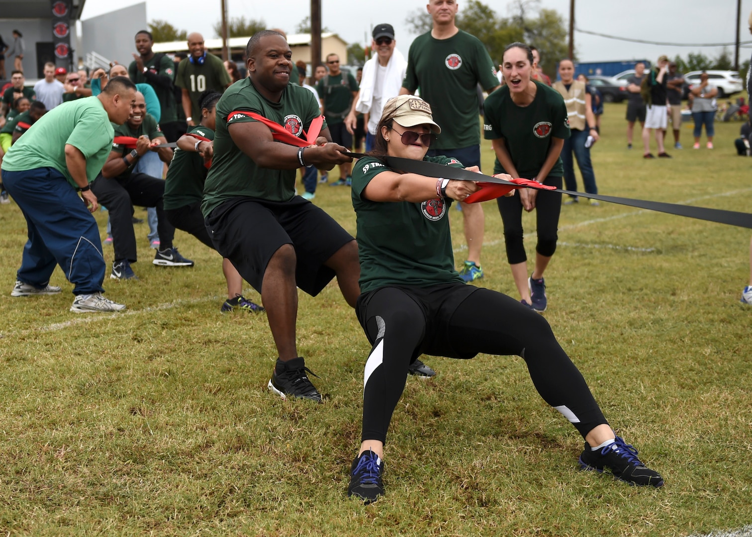 Airmen from the 59th Training Group try to move the heptagonal metal disc in their direction during the Warrior Medic Challenge seven-way tug-of-war held Nov. 4 on Joint Base San Antonio-Lackland, Texas. The event brought civilian and active-duty members of the 59th Medical Wing’s seven groups together for a day of friendly, spirited competition. The Warrior Medical Challenge is designed to build camaraderie amongst members of the wing. (U.S. Air Force photo/Staff Sgt. Kevin Iinuma)