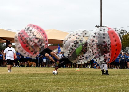Airmen run into each other during the Knockerball competition on Joint Base San Antonio-Lackland, Texas, Nov. 4. Seven competitors – one from each group – were on the field at a same time trying to get the soccer ball into their group’s goal. (U.S. Air Force photo/Staff Sgt. Kevin Iinuma)