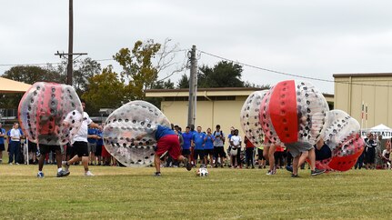 Airmen tackle each other to get the upper hand and a chance to score a goal during the Knockerball competition on Joint Base San Antonio-Lackland, Texas, Nov. 4. The 359th Medical Group and the 959th Medical Group tied for first place during the event. (U.S. Air Force photo/Staff Sgt. Kevin Iinuma)