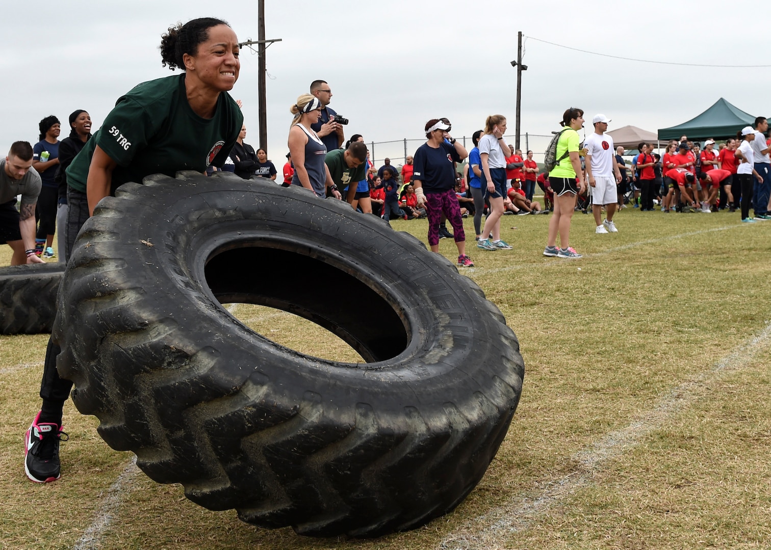 Master Sgt. La’Kisha Thomas, 59th Training Group military training leader and flight chief, flips a tire during the 59th Medical Wing Warrior Medic Challenge held Nov. 4 on Joint Base San Antonio-Lackland, Texas. The event brought members of the 59th Medical Wing together at the Gillum Fitness Center and Sports Complex for a day of friendly, spirited competition. Warrior Medic Challenge is designed to build camaraderie amongst members of the wing. (U.S. Air Force photo/Staff Sgt. Kevin Iinuma)