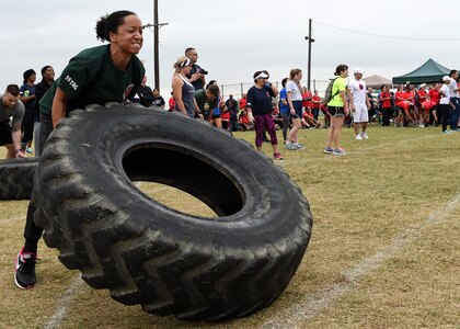 Master Sgt. La’Kisha Thomas, 59th Training Group military training leader and flight chief, flips a tire during the 59th Medical Wing Warrior Medic Challenge held Nov. 4 on Joint Base San Antonio-Lackland, Texas. The event brought members of the 59th Medical Wing together at the Gillum Fitness Center and Sports Complex for a day of friendly, spirited competition. Warrior Medic Challenge is designed to build camaraderie amongst members of the wing. (U.S. Air Force photo/Staff Sgt. Kevin Iinuma)