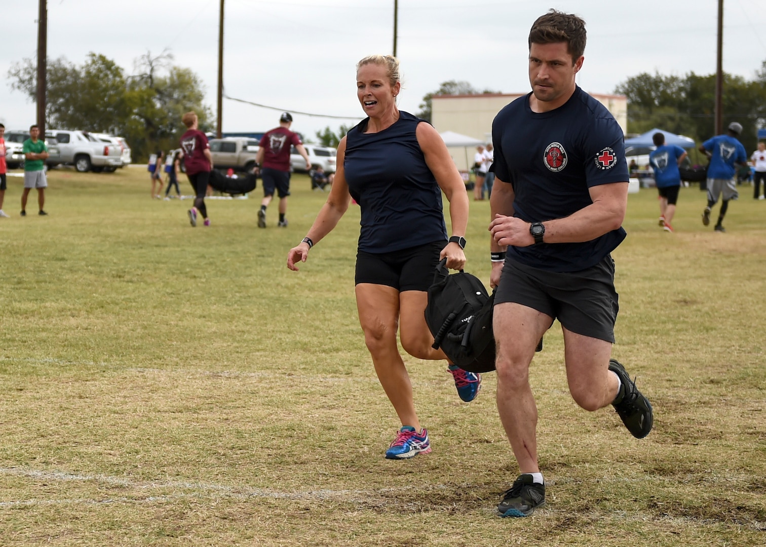 The 59th Medical Operations Group team carries a 100-pound sandbag during the ‘Don’t Sand Bag Me, Bro’ competition Nov. 4 on Joint Base San Antonio-Lackland, Texas. Teams worked in pairs, competing to be the first to carry the sandbag 600 total feet. (U.S. Air Force photo/Staff Sgt. Kevin Iinuma)