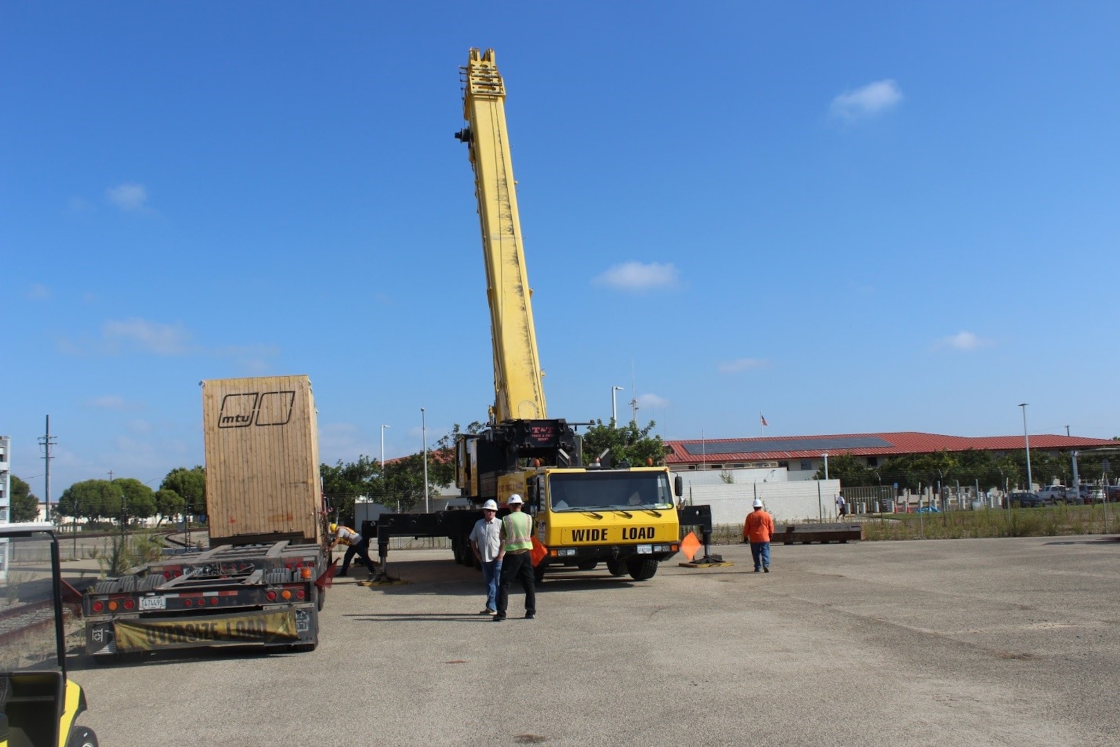 The commercial crane crew sets up the crane for engine offload. This engine weighs 122,000 pounds and is over 26 feet long.
