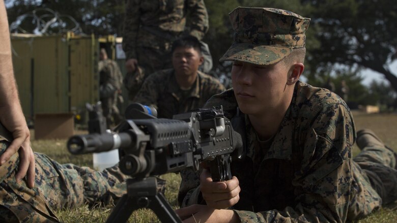 Pfc. Caleb Lebrun, a radio operator with Combat Logistics Battalion 6, listens to an instructor as they review the steps of operating a M240B medium machine gun during a command post exercise at Bogue Marine Corps Auxiliary Landing Field, N.C., Nov. 3, 2016. Marines learned how to operate weapons they might use on deployment as CLB 6 prepares for their Marine Corps Combat Readiness Evaluation.