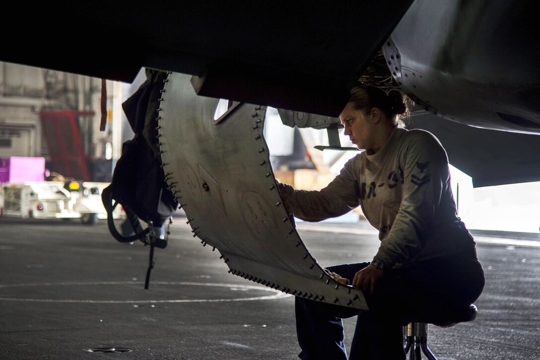 Navy Petty Officer 2nd Class Carlah Robbins performs an 84-day inspection on an F/A-18F Super Hornet in the hangar bay of the aircraft carrier USS Dwight D. Eisenhower in the Persian Gulf, Nov. 7, 2016. The aircraft is assigned to Strike Fighter Squadron 32. Robbins is an aviation structural mechanic. Navy photo by Petty Officer 3rd Class Nathan T. Beard
