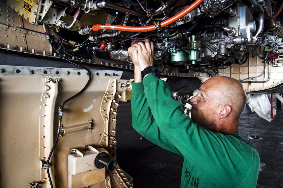 Navy Petty Officer 1st Class Robert Neely reads wires on a full authority digital electronic control in the hangar bay of the aircraft carrier USS Dwight D. Eisenhower in the Persian Gulf, Nov. 7, 2016. Neely is an aviation electrician’s mate. Navy photo by Petty Officer 3rd Class Nathan T. Beard