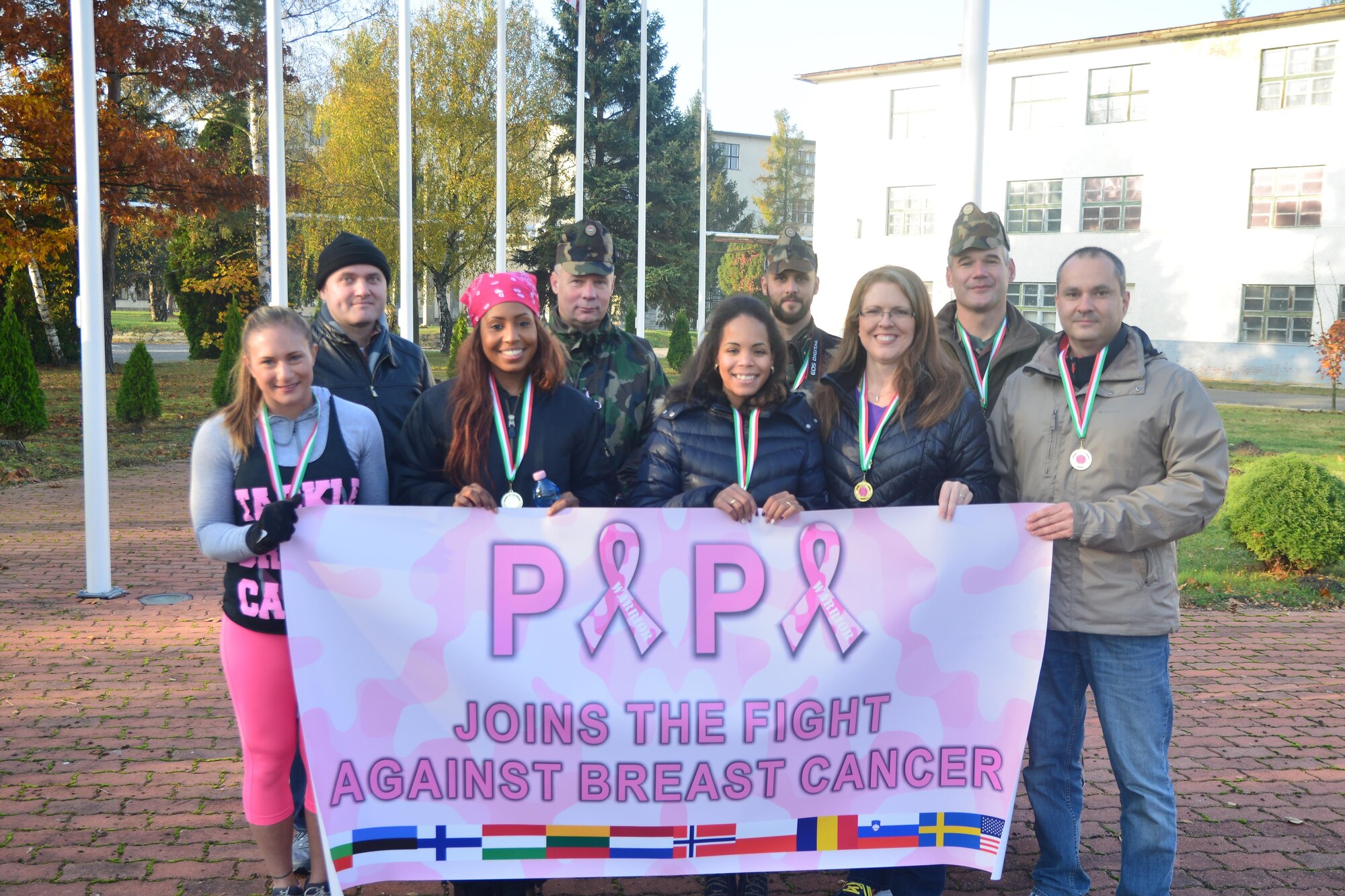 Volunteers from Team Aviano and the Heavy Airlift Wing participate in an annual Breast Cancer Awareness Walk at Papa Air Base, Hungary on Oct 28, 2016. More than 145 attendees from 12 countries participated in the event to support breast cancer awareness. (Courtesy photo)