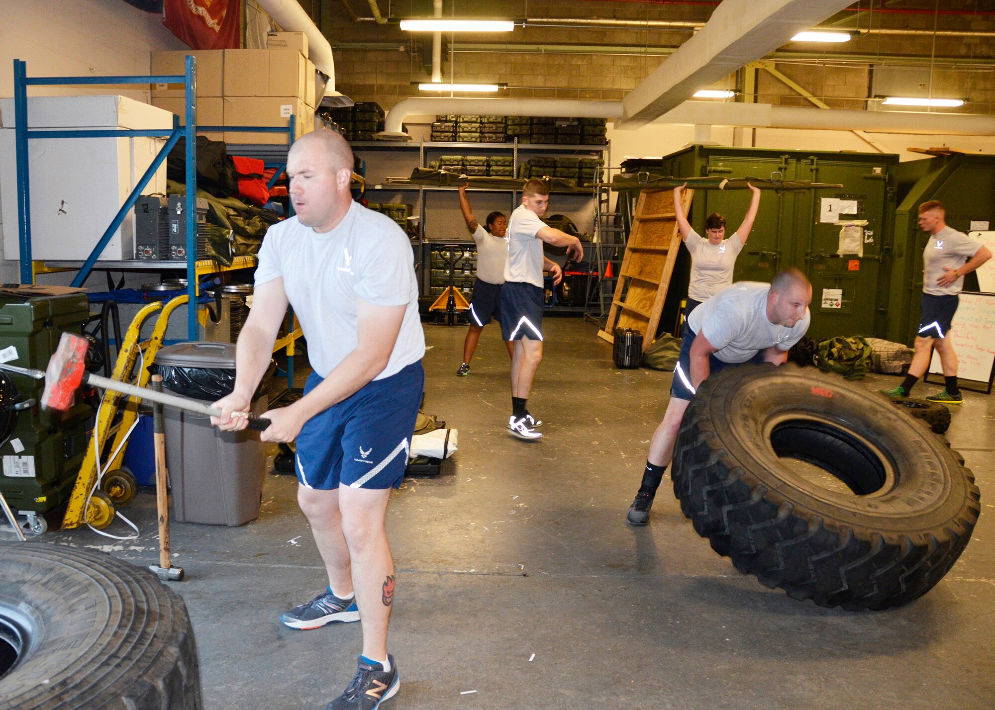During the one hour workout, Airmen from the 445th Security Forces Squadron workout using duty equipment to perform functional movements, including a shoulder press with a medical litter, sledgehammer strikes and a tire flip. (U.S. Air Force photo/Staff Sgt. Rachel Ingram)