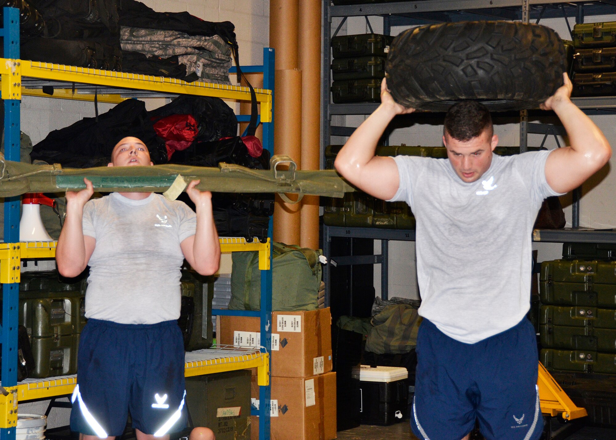 Airmen from the 445th Security Forces Squadron workout using duty equipment to perform functional movements, like a shoulder press with a medical litter and vehicle tire. The innovative program was designed by Staff Sgt. Shayne Denihan. (U.S. Air Force photo/Staff Sgt. Rachel Ingram)