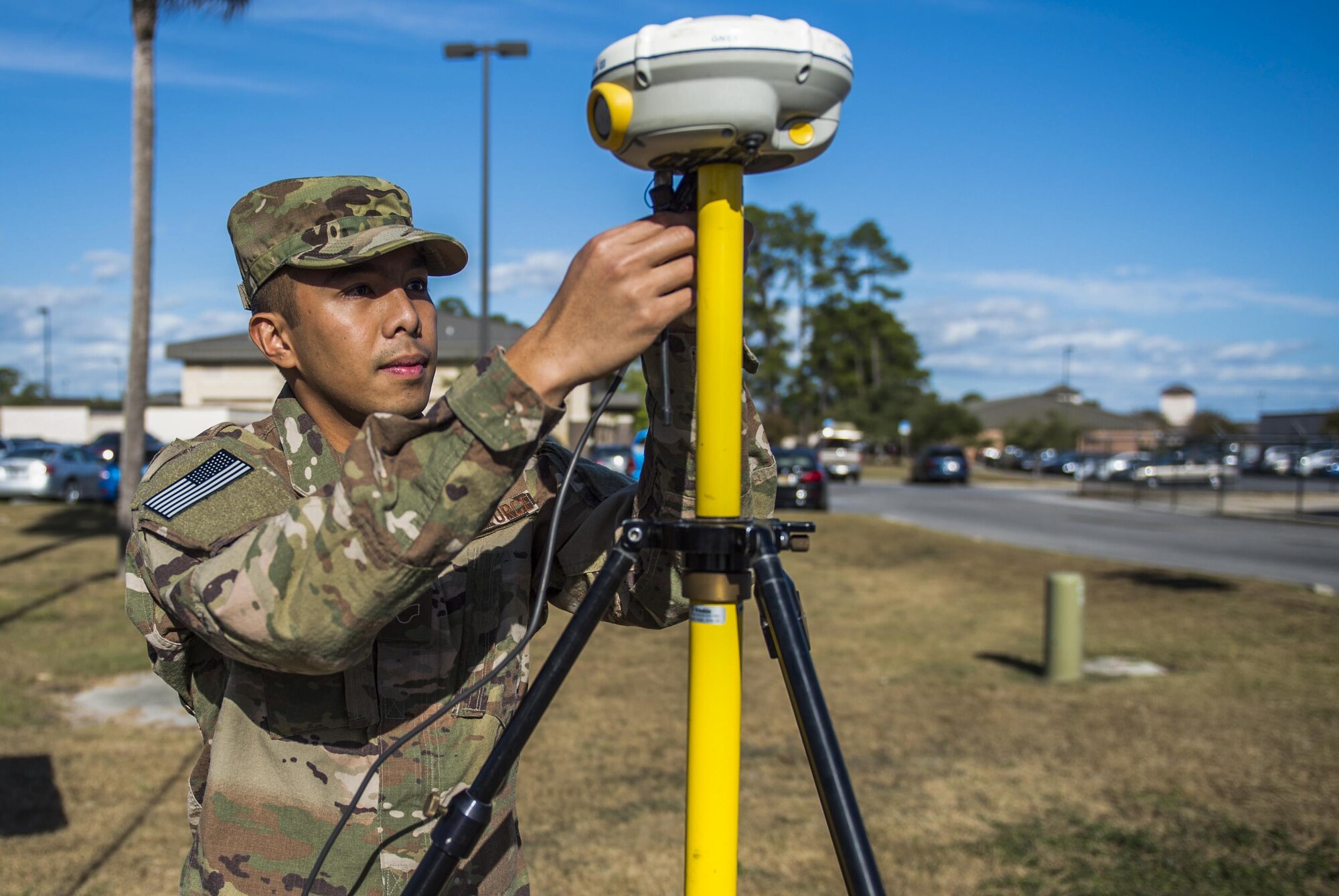 Senior Airman Giann Recapunra, an engineering specialist with the 1st Special Operations Civil Engineer Squadron, sets up a surveying GPS to verify the location and elevation of facilities on Hurlburt Field, Fla., Nov. 7, 2016. Engineering specialists use surveys to collect input data for the installation geobase database and typography to assist engineering designs for new structures.(U.S. Air Force photo by Airman 1st Class Isaac O. Guest IV)
