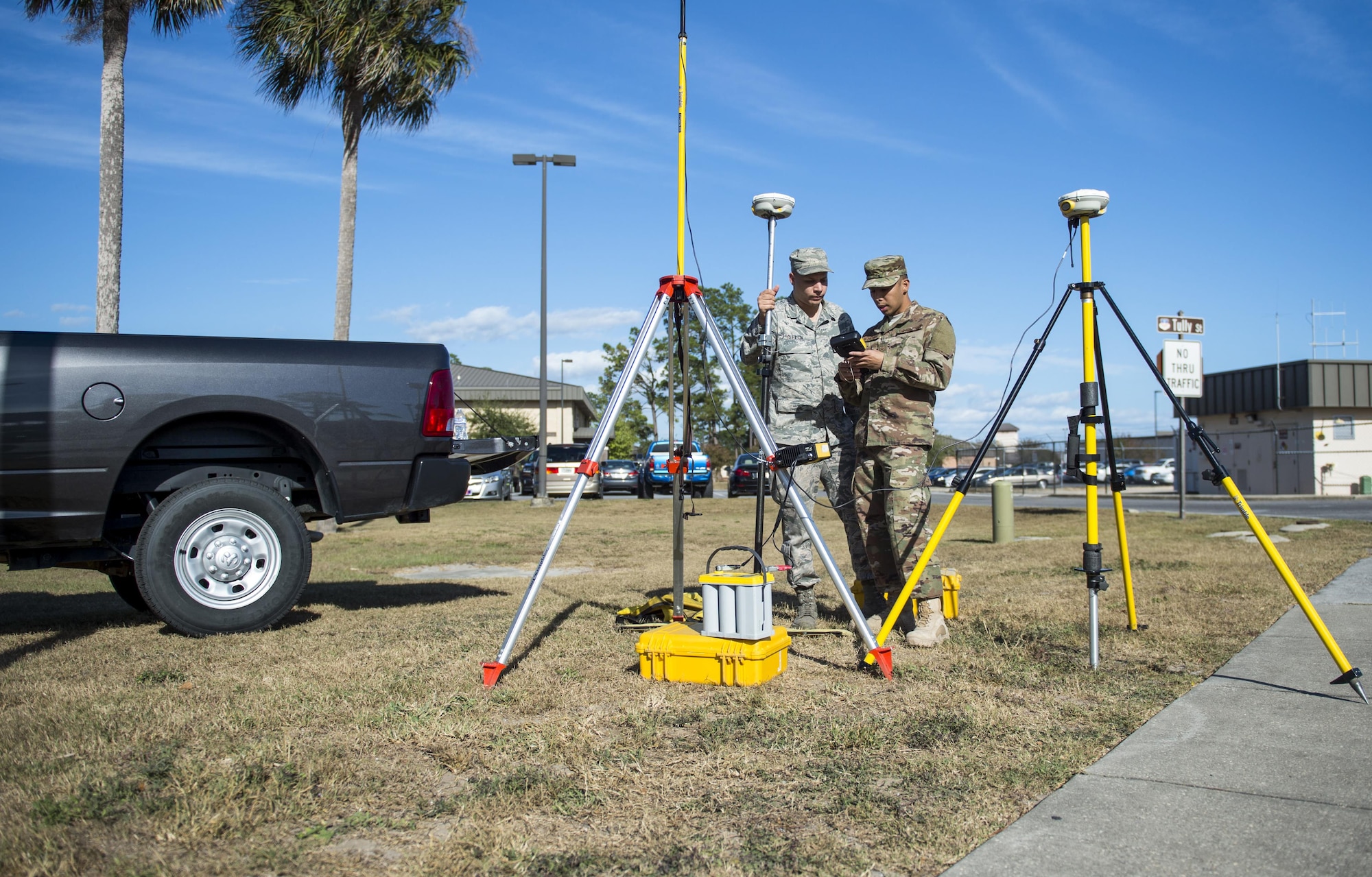 Senior Airmen Giann Recapuna and Adam Gleason, engineering specialists with the 1st Special Operations Civil Engineer Squadron, set up a GPS to survey and verify the location and elevation of facilities at Hurlburt Field, Fla., Nov. 7, 2016. Engineering specialists use surveys to collect input data for the installation geobase database and typography to assist engineering designs for new structures. (U.S. Air Force photo by Airman 1st Class Isaac O. Guest IV)