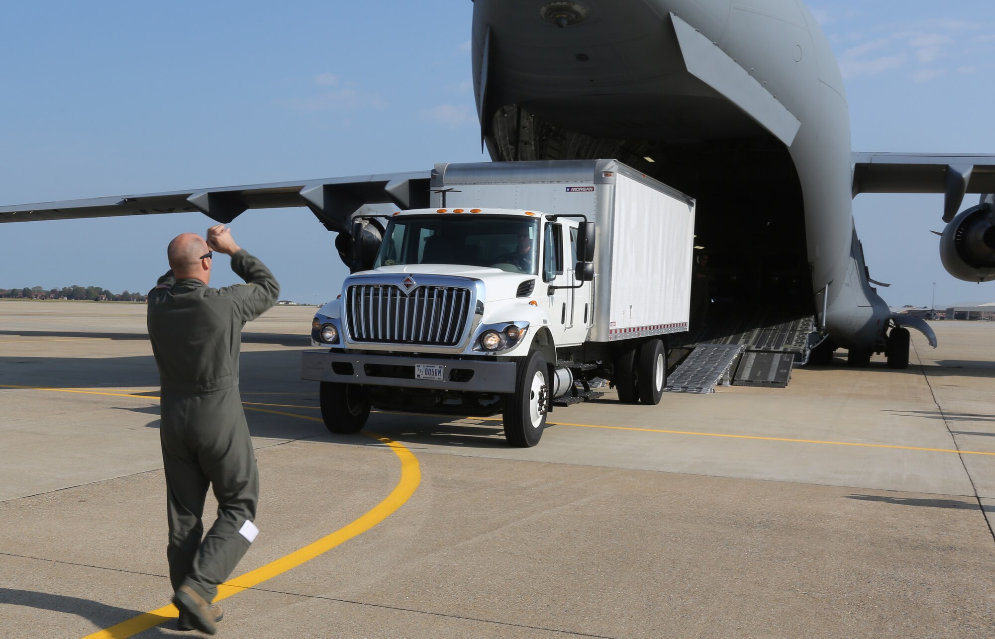 U.S. Air Force Staff Sgt. Robert Russell, a loadmaster with the 315th Airlift Wing, directs the driver into the Boeing C-17 Globermaster III at Joint Base Langley-Eustis, Va., Nov. 2, 2016. Loading the vehicles on to the C-17 is part of a deployment readiness exercise held by Joint Task Force Civil Support.  If practice makes perfect, then JTF-CS is ready to be called up with the right force, right response, and right expertise. (Official DOD photo by Ms. Tammy Cario)