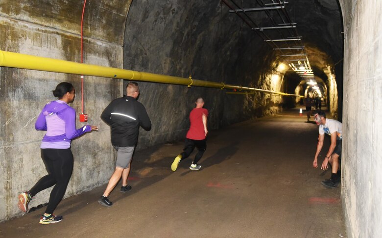 CHEYENNE MOUNTAIN AIR FORCE STATION, Colo. – Runners try to avoid zombies in the tunnel of Cheyenne Mountain during the Zombie 5K at Cheyenne Mountain Air Force Station, Colo., Nov. 4, 2016. Zombies hid in the shadows or behind ledges to scare runners as they passed. (U.S. Air Force photo by David Meade)